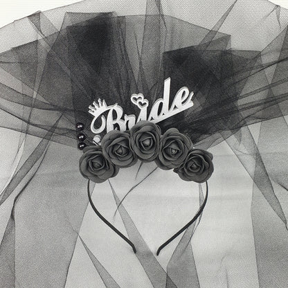a black and white photo of roses on a veil