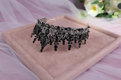 a tiara on a tray with flowers in the background