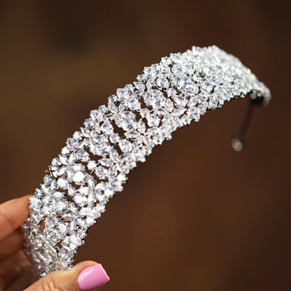 a close up of a person holding a tiara