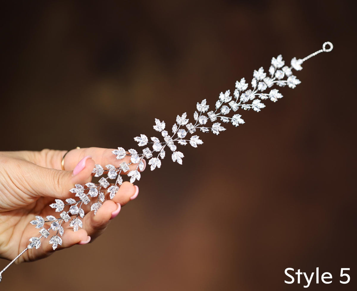 a person holding a piece of jewelry in their hand