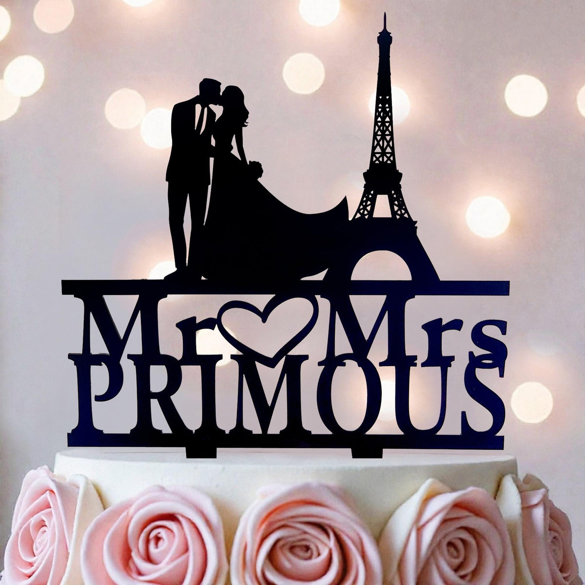 A silhouette of a couple embracing in front of the Eiffel Tower, with the words "Mr. Primous" written below.