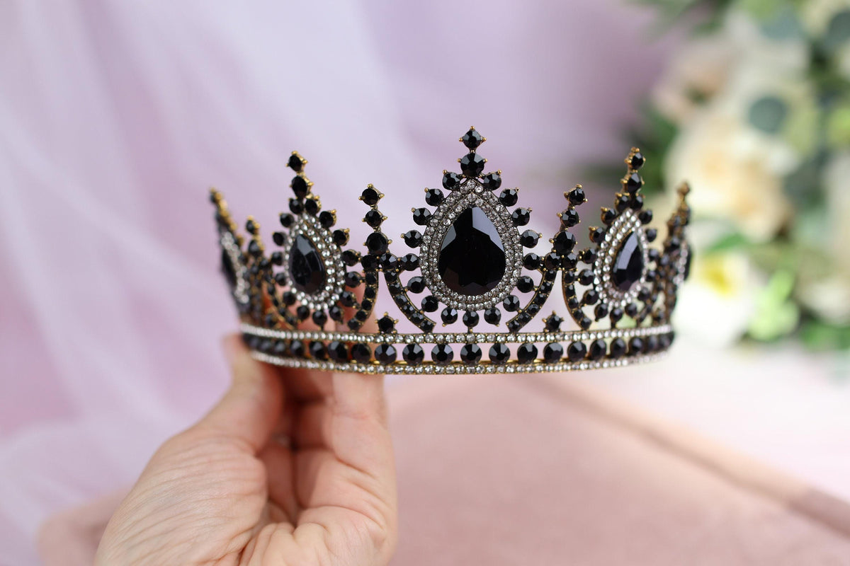 a person holding a tiara in their hand