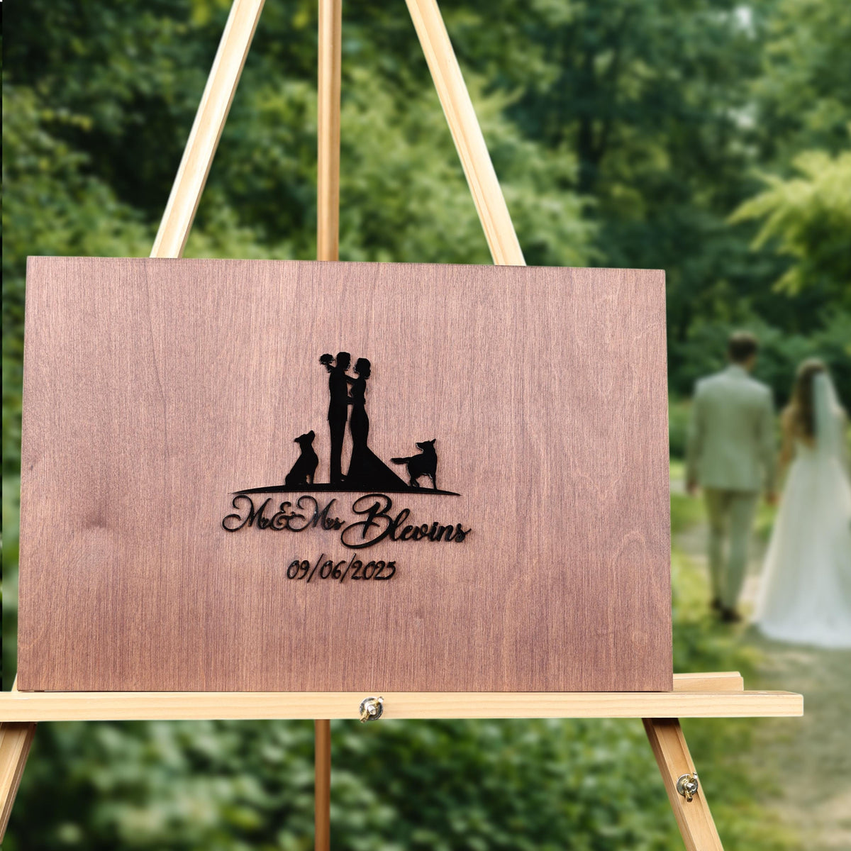 A wooden sign displaying a silhouette of a couple embracing, with the text "Mr & Mrs Blooms" and the date "09/06/2023" on it.