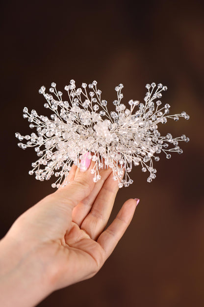 a hand holding a piece of white plastic