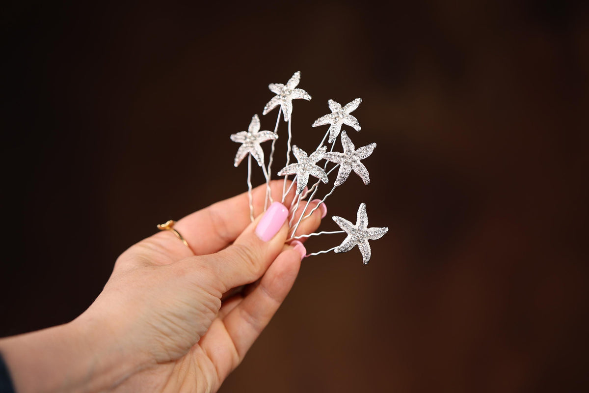 a person holding a small white flower on a stick