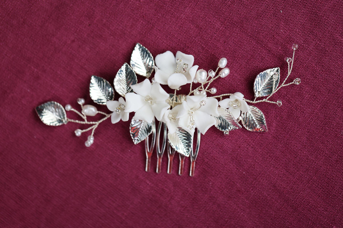 a hair comb with flowers and leaves on it