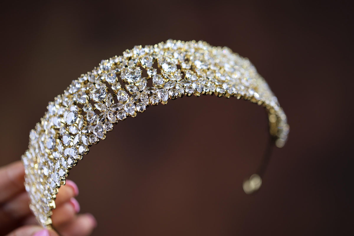 a close up of a person holding a piece of jewelry