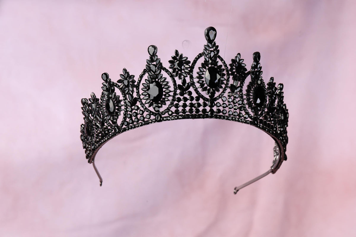 a black tiara on a pink background