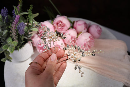 a person holding a flower in front of a bouquet of flowers