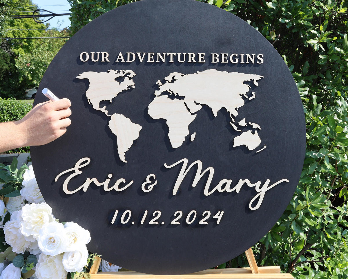 a person writing on a sign with a world map on it