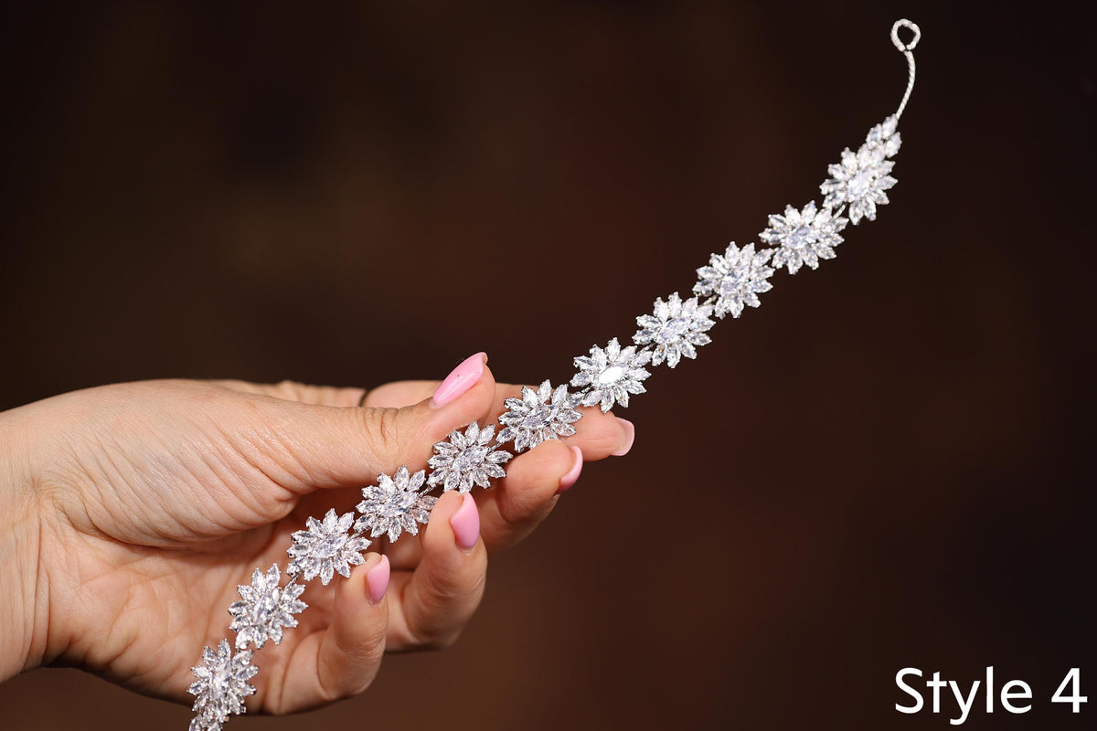 a woman's hand holding a diamond bracelet
