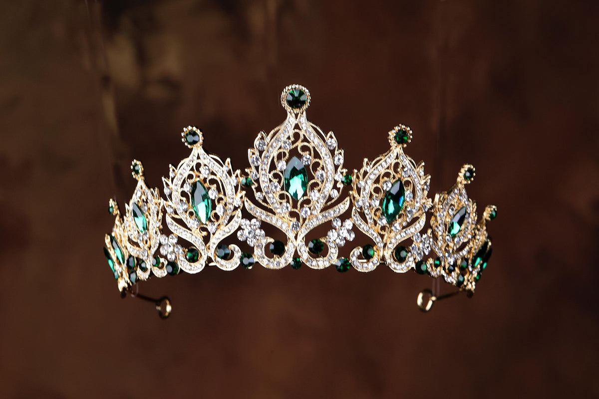 a tiara with green and white stones on it