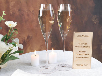 two glasses of champagne sitting on a table