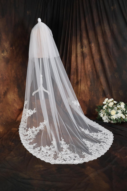 a wedding veil with a bouquet of flowers in the background