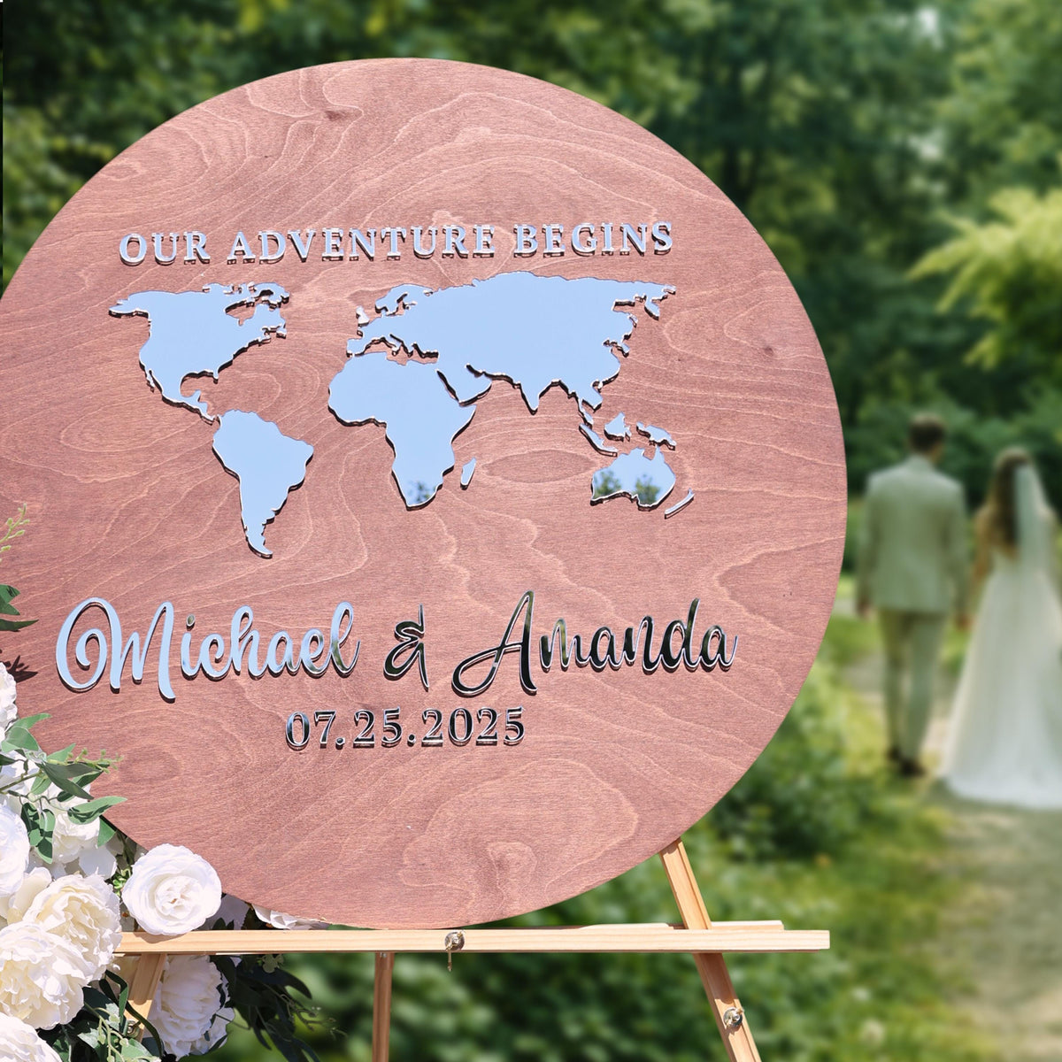 A wooden sign with a world map and the names "Michael & Avianca" written on it, along with the date "07.25.2025".