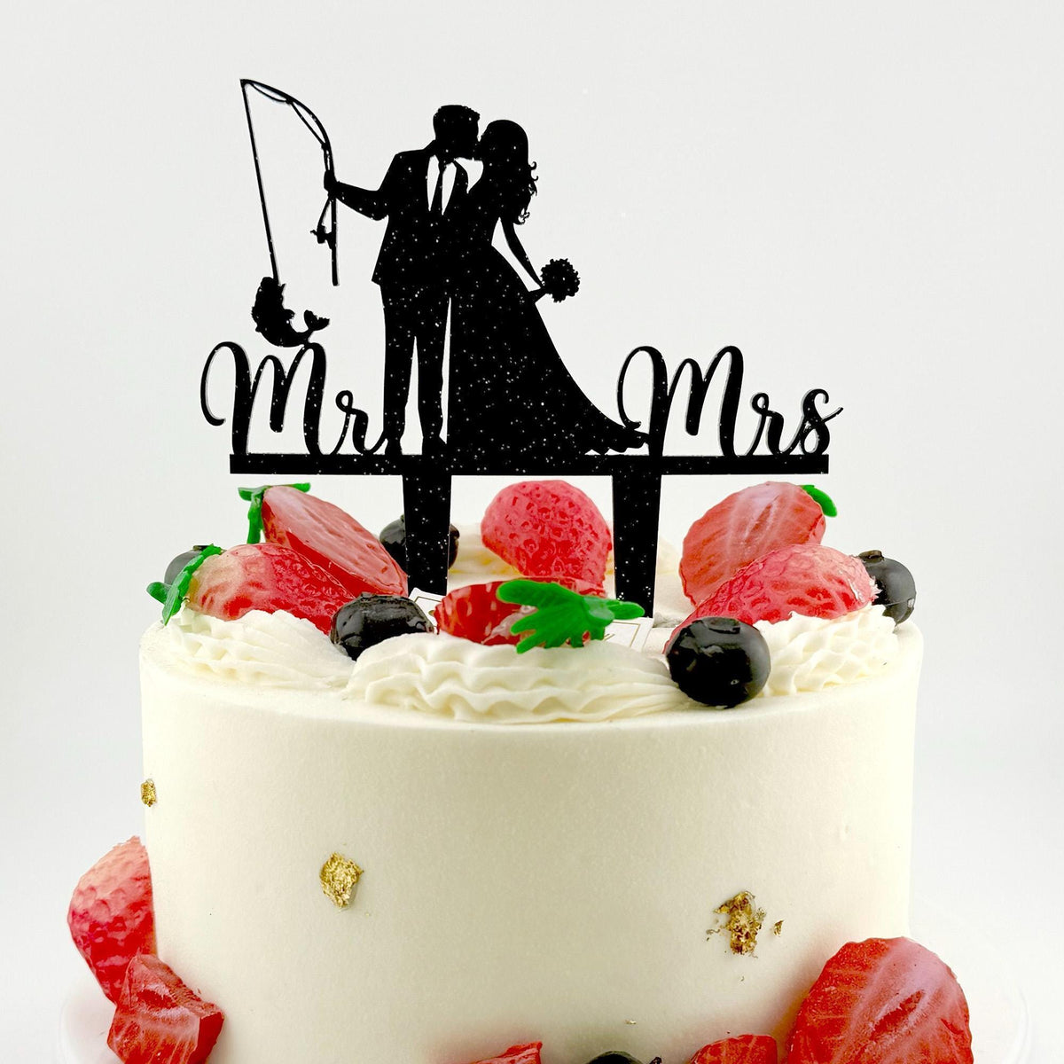 a cake with a silhouette of a couple on top of it