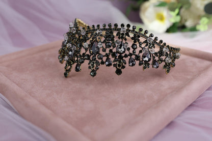 a close up of a tiara on a pink cloth