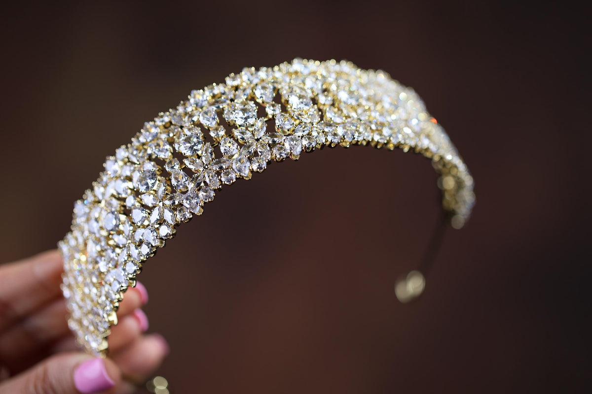 a close up of a person holding a piece of jewelry