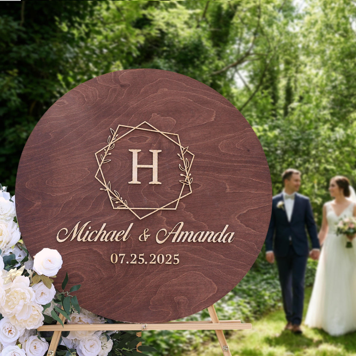 A wooden sign with the initials "H" and the names "Michael & Amanda" is displayed in a garden setting, with a couple walking in the background.
