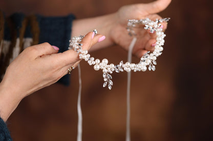 a close up of a person holding a piece of jewelry