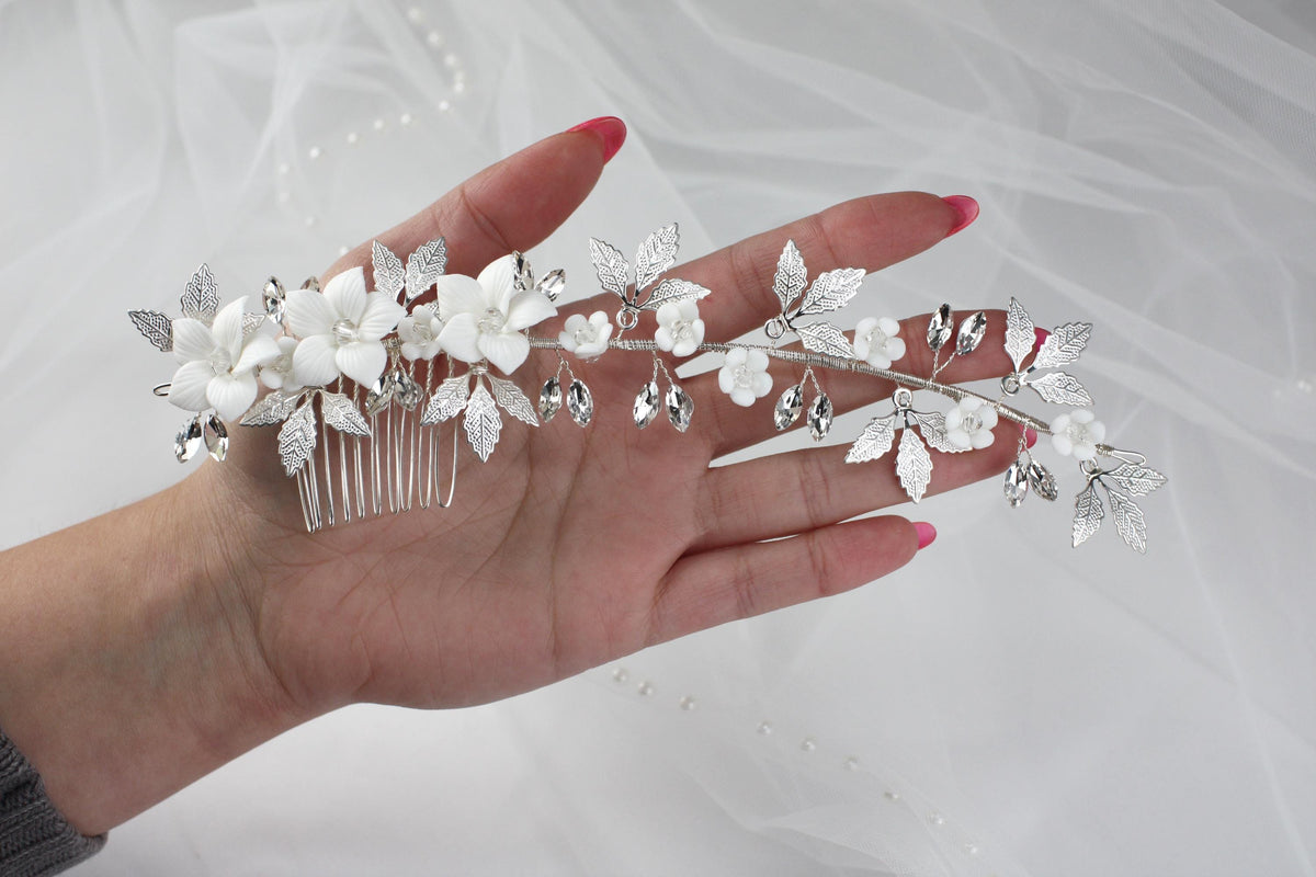 a woman's hand holding a bridal hair comb