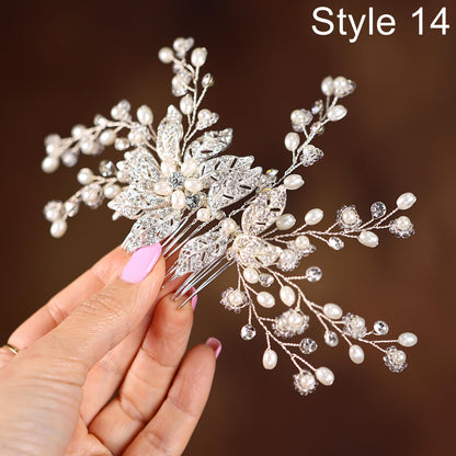 A hand holding a decorative hair accessory with intricate silver and white embellishments, including leaves and pearls.