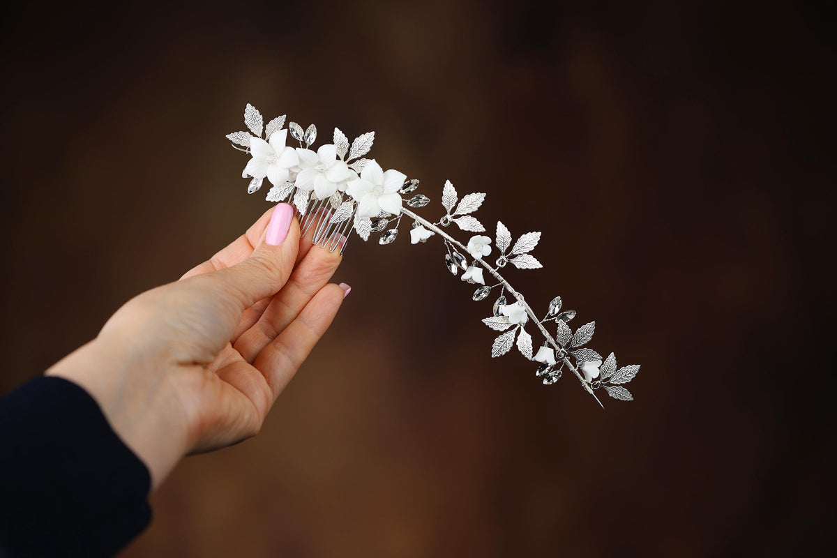 a person holding a white flower in their hand