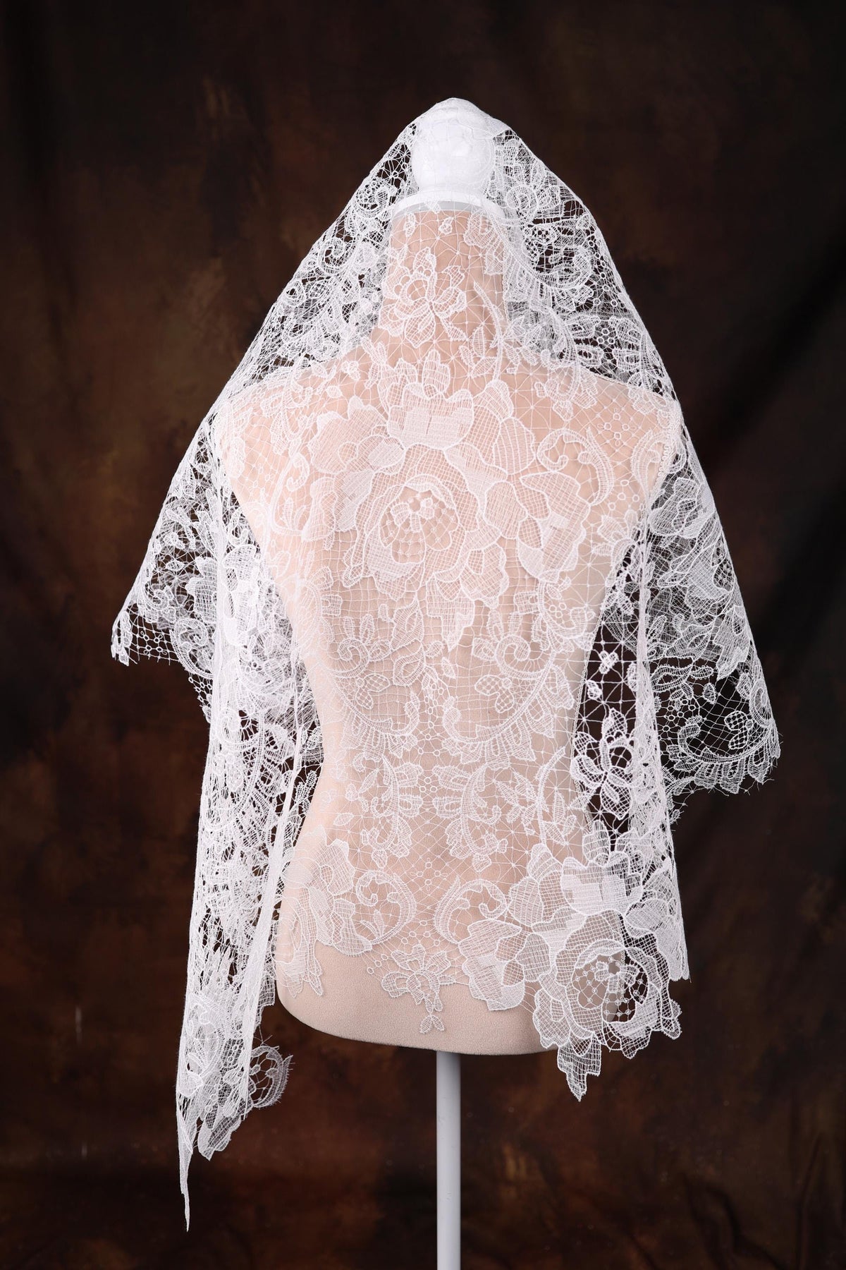 a mannequin wearing a wedding veil on a mannequin