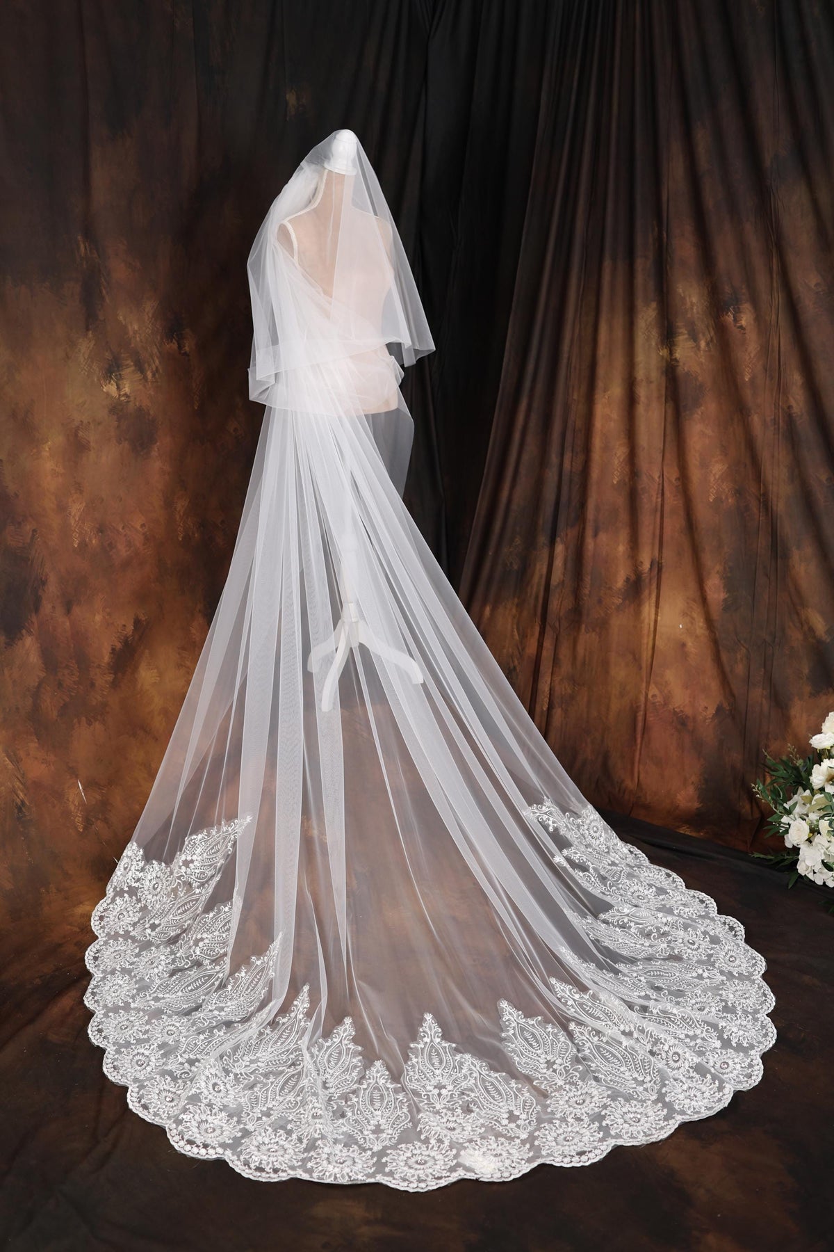 a bridal veil with white flowers on it