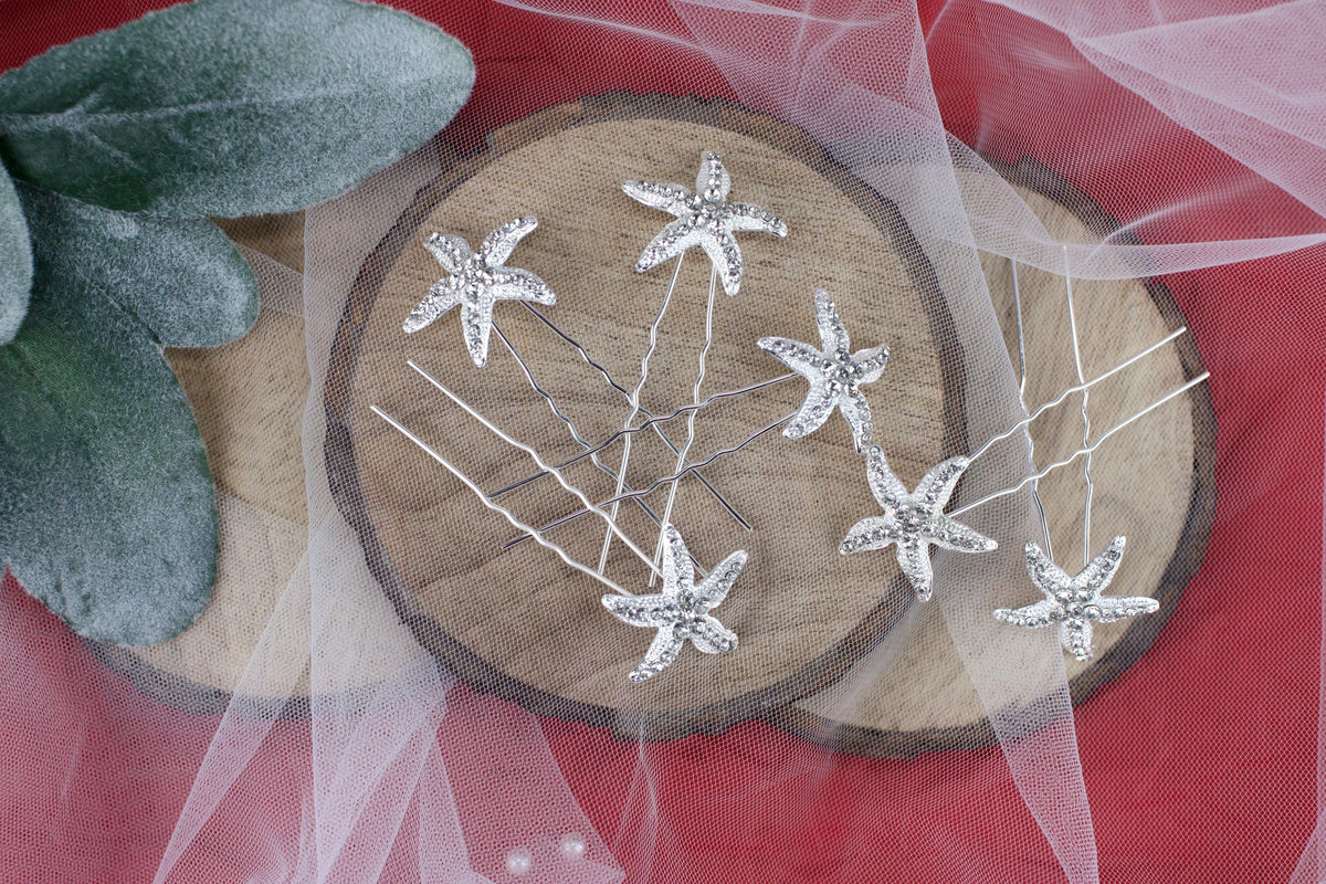 a close up of a bunch of pins on a piece of wood