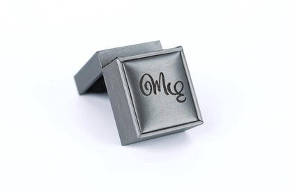 A silver-colored box with the word "Me" printed on it.