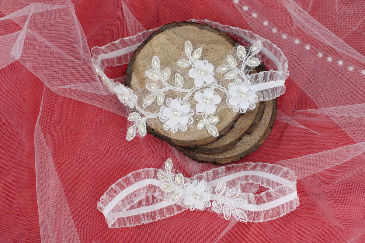 a pair of headbands with flowers on a piece of wood