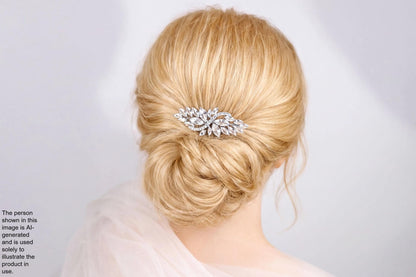 A close-up view of a woman's blonde hair with a decorative hair accessory, such as a flower or crystal piece, in the back of her head.