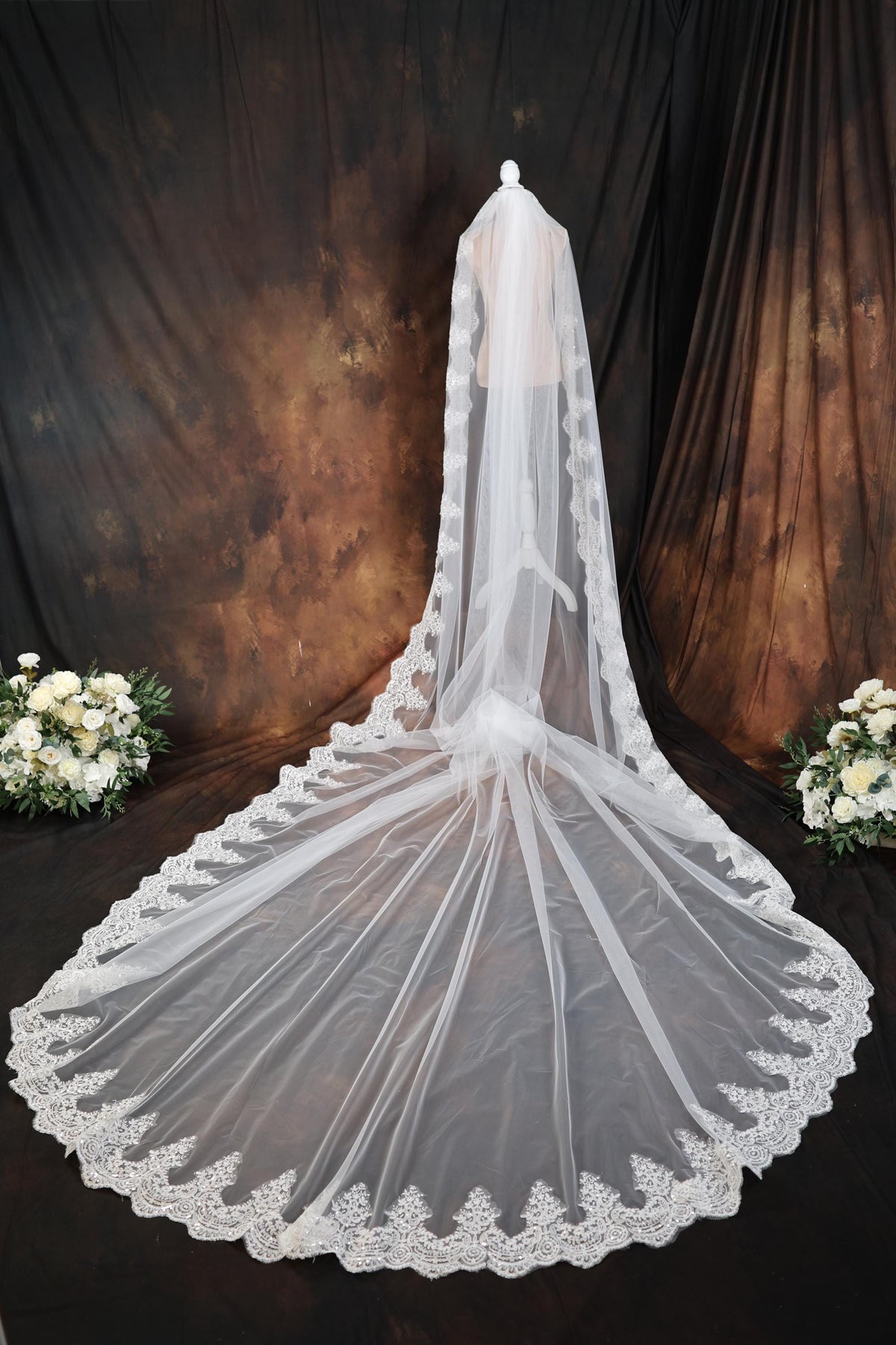 a wedding veil with a bouquet of flowers