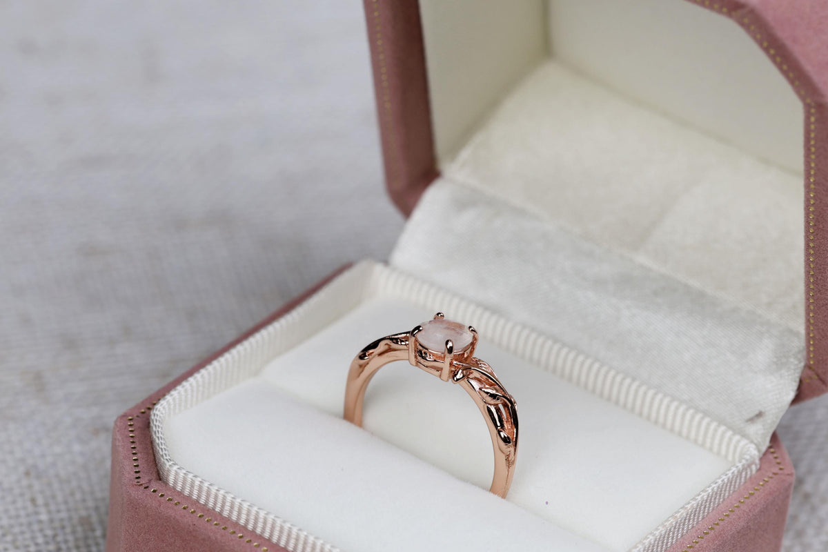 a diamond ring in a pink velvet box