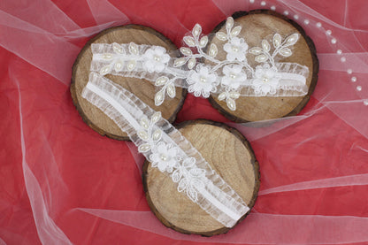 a pair of wooden shoes with white lace and flowers on them
