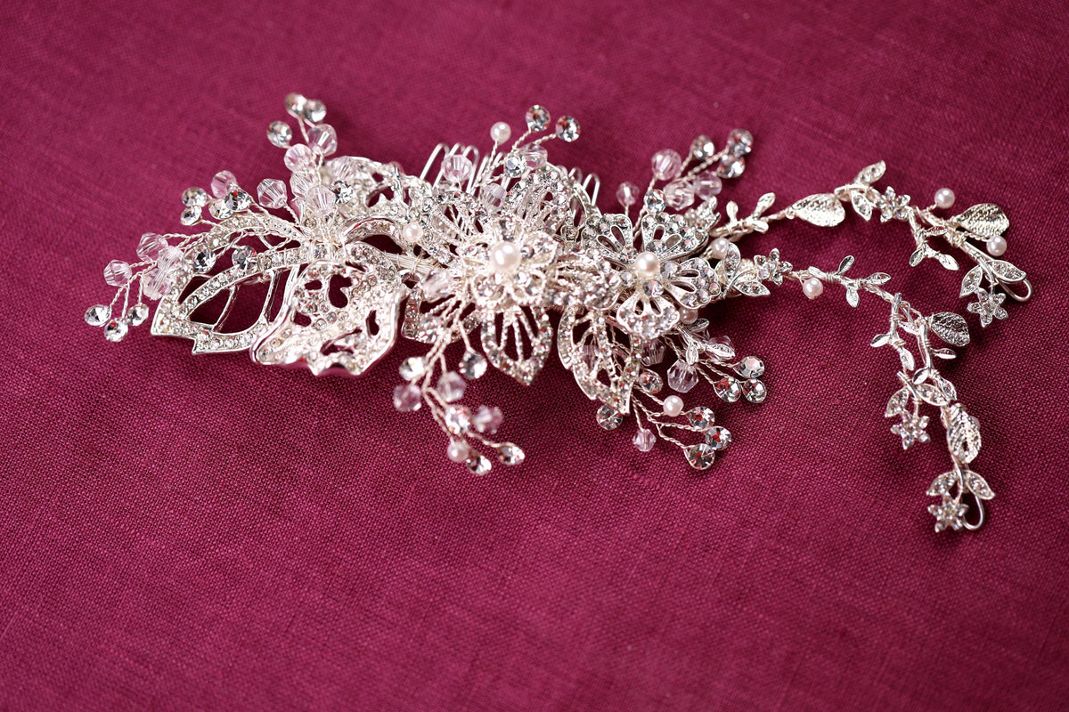 a close up of a brooch on a purple cloth
