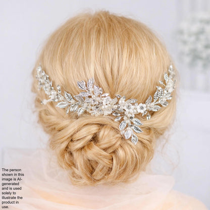 the back view of a woman's blonde hair with a decorative hair accessory, which appears to be a floral or leaf-shaped piece.