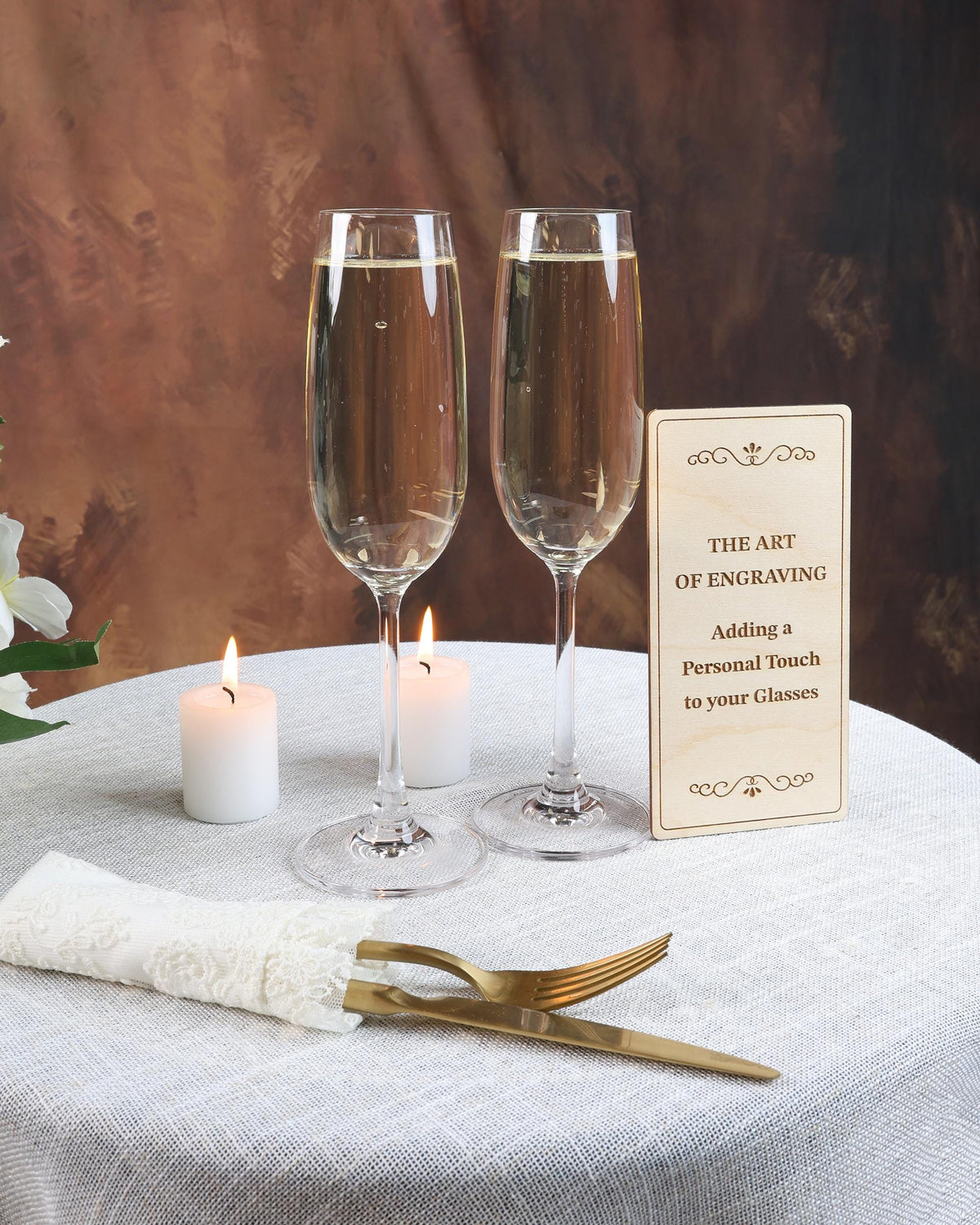 two glasses of wine on a table with a sign