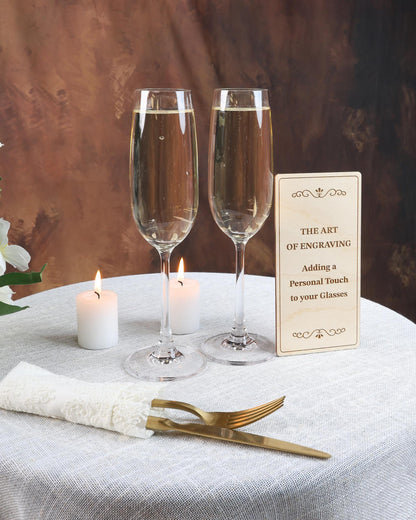 two glasses of wine on a table with a sign