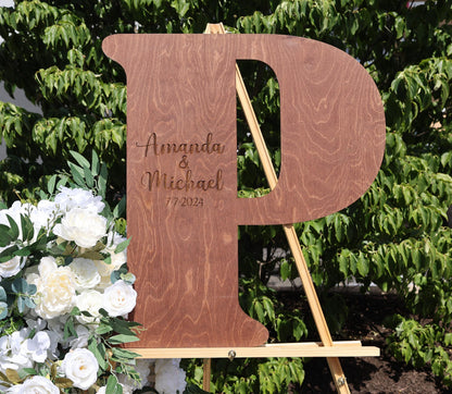 a wooden sign sitting next to a bouquet of flowers