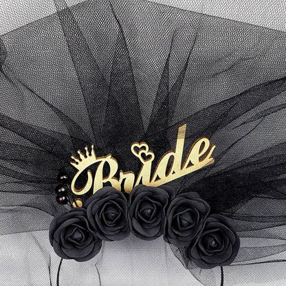 a black veil with a gold crown and the word "Bride" written on it, along with black roses.