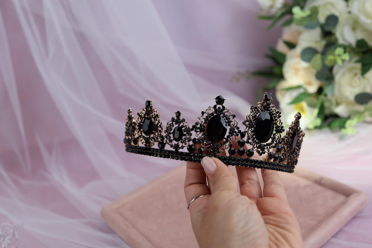 a woman holding a tiara in her hand