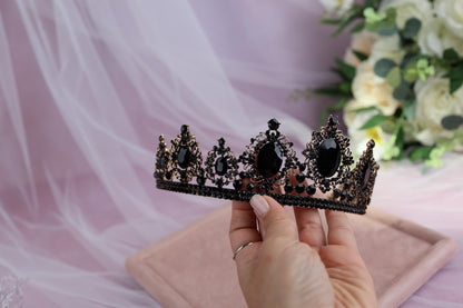 a woman holding a tiara in her hand