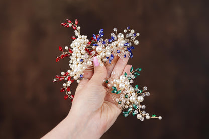 a hand holding a bunch of small white and red flowers