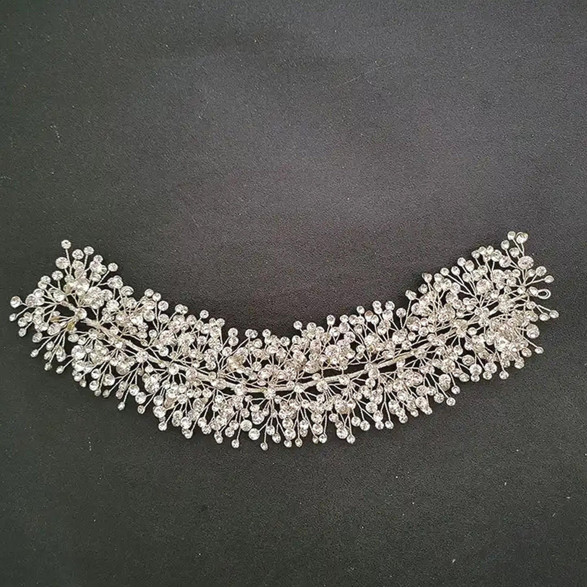 a close up of a tiara on a black surface