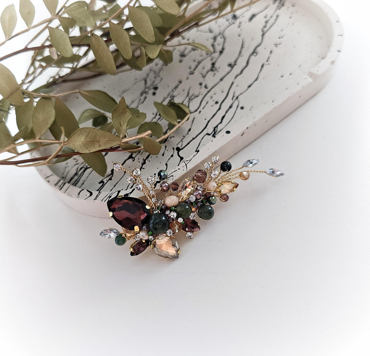 a close up of a pair of earrings on a white surface