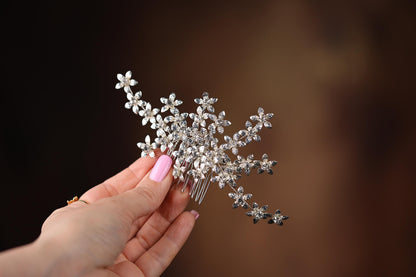 a woman holding a crystal flower hair comb