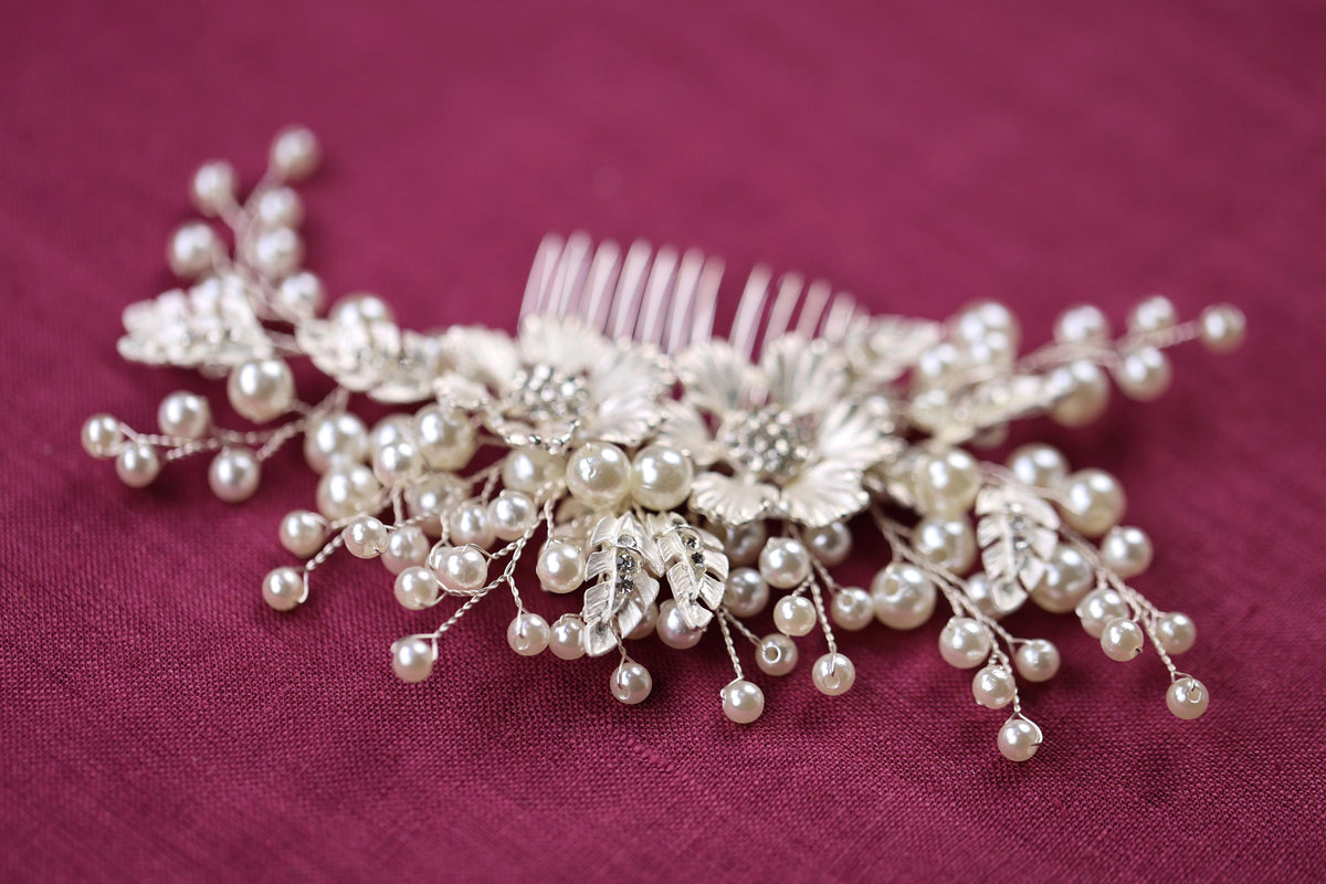 a close up of a hair comb with pearls