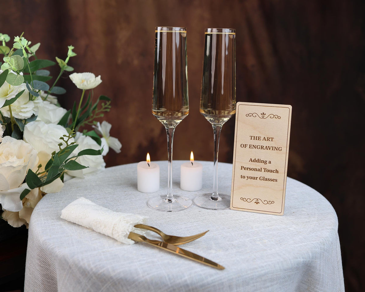 a table topped with two wine glasses and two candles
